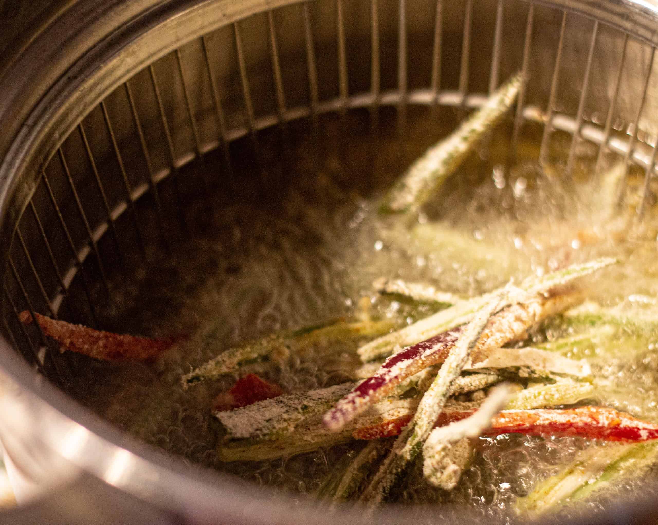 Frying the okra bhindi