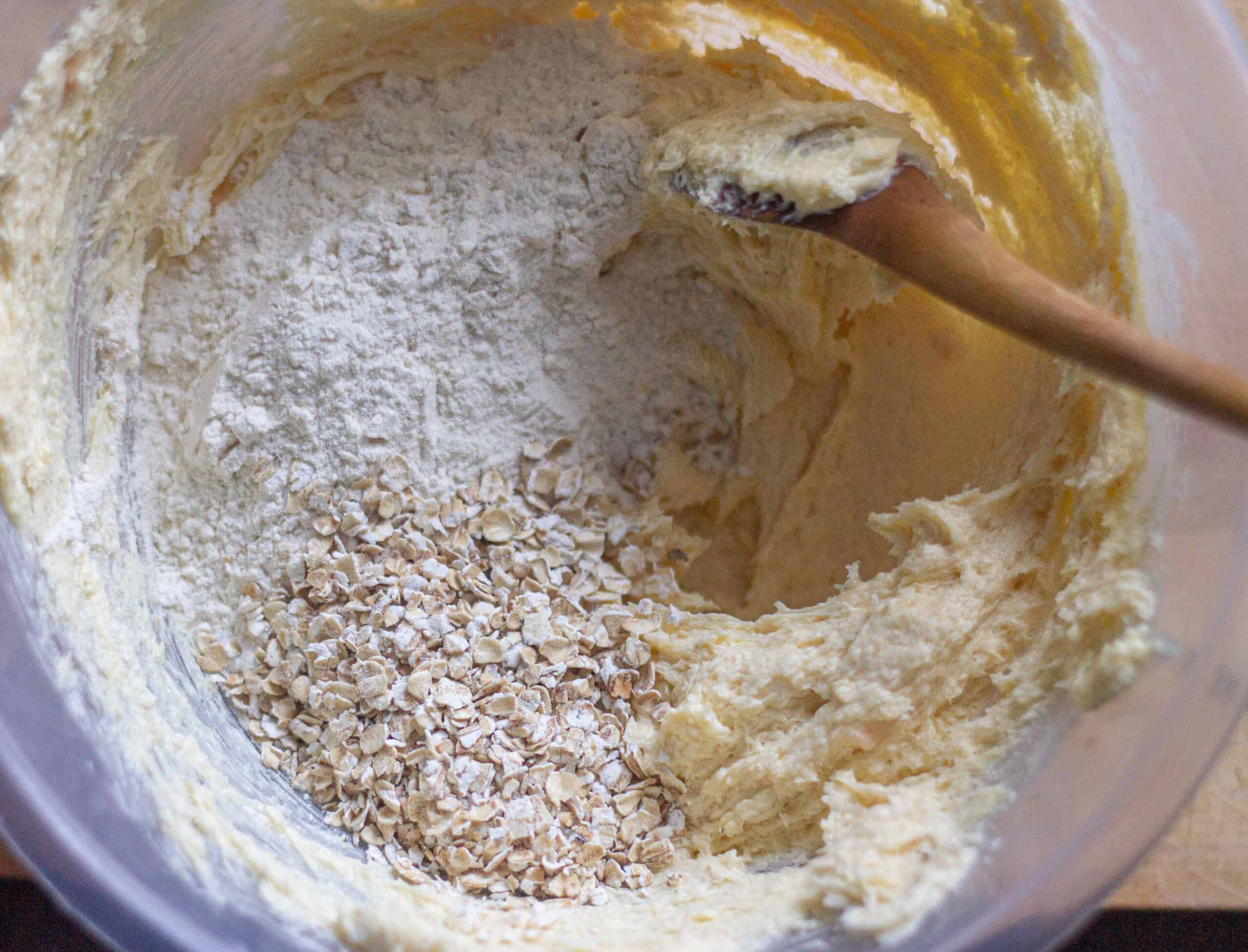 Adding oats and flour to butter and sugar