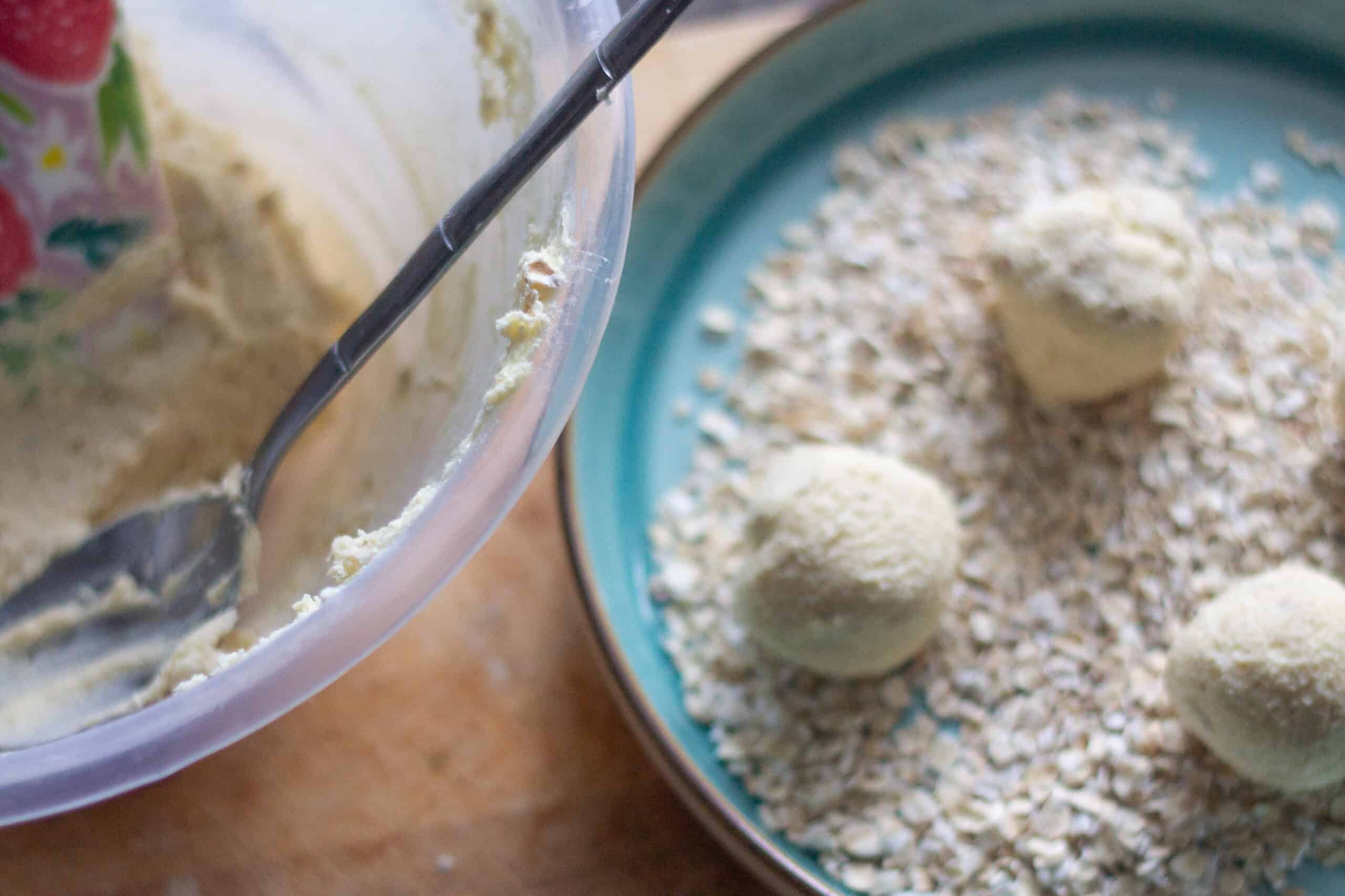 Rolling cookie dough in oats