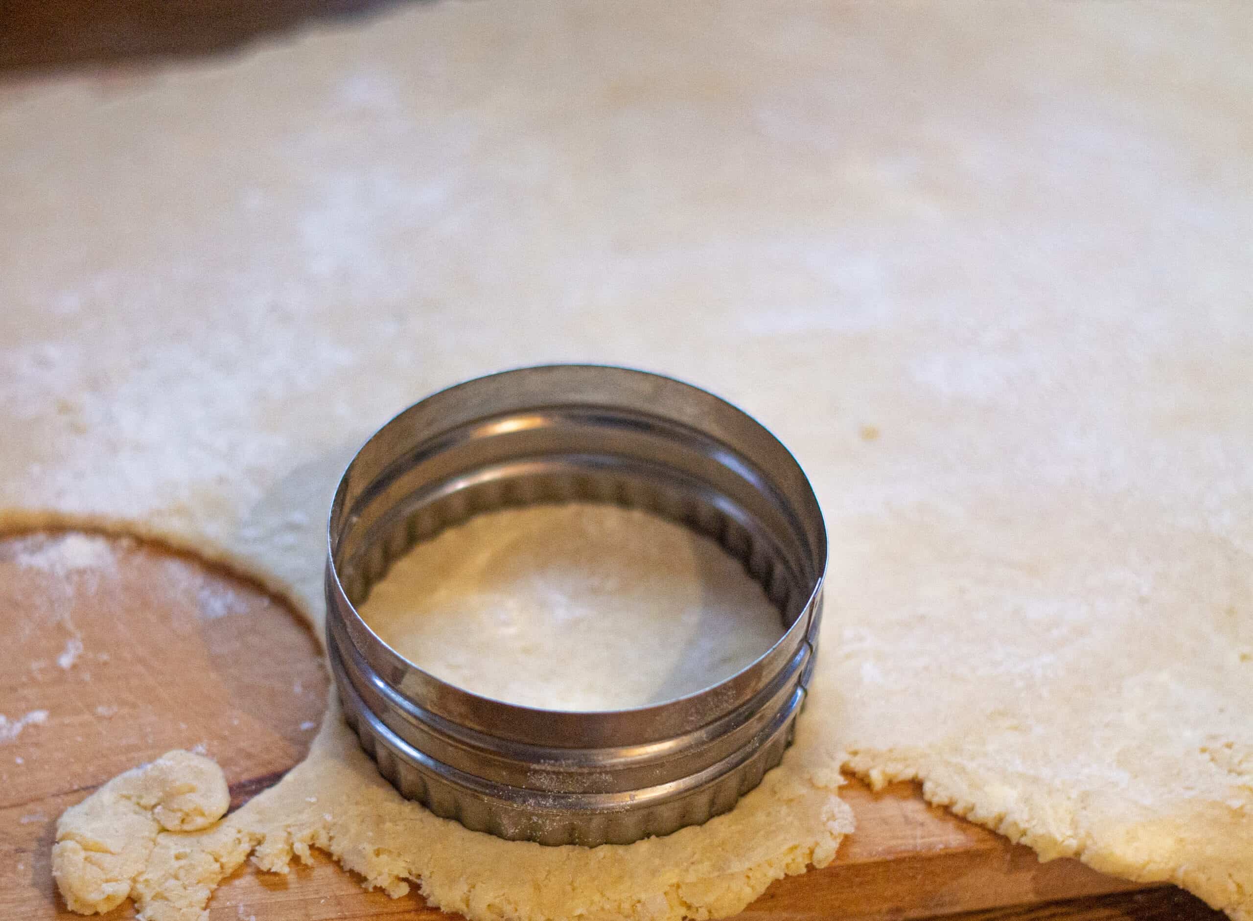 Rolled out dough being cut into circles