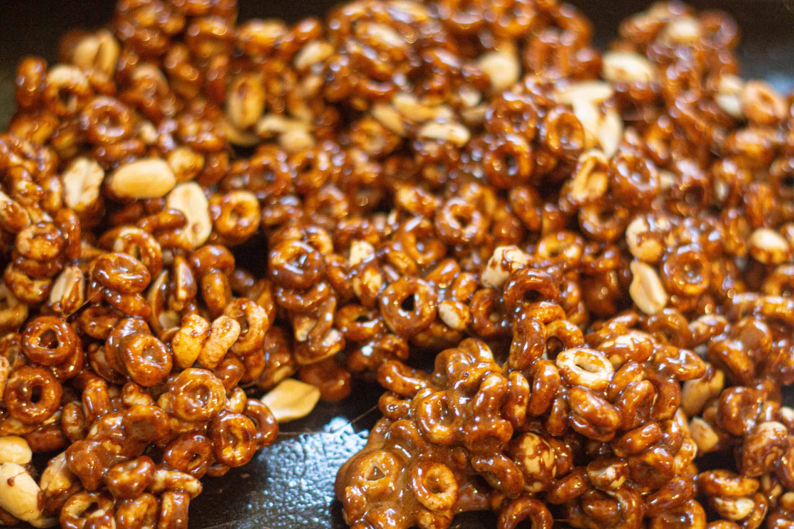 Mixing caramel into cheerios