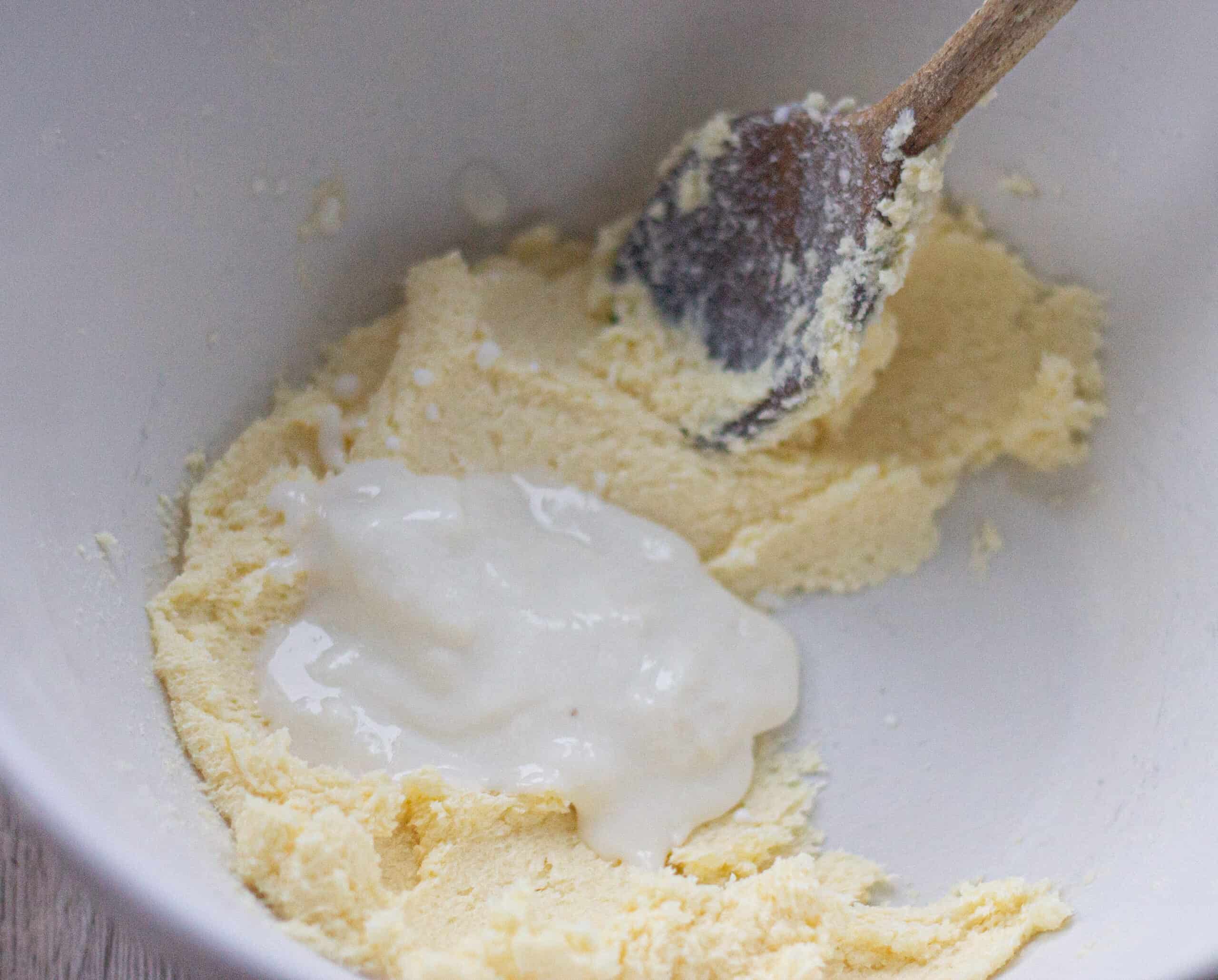 Adding yogurt to creamed butter and sugar