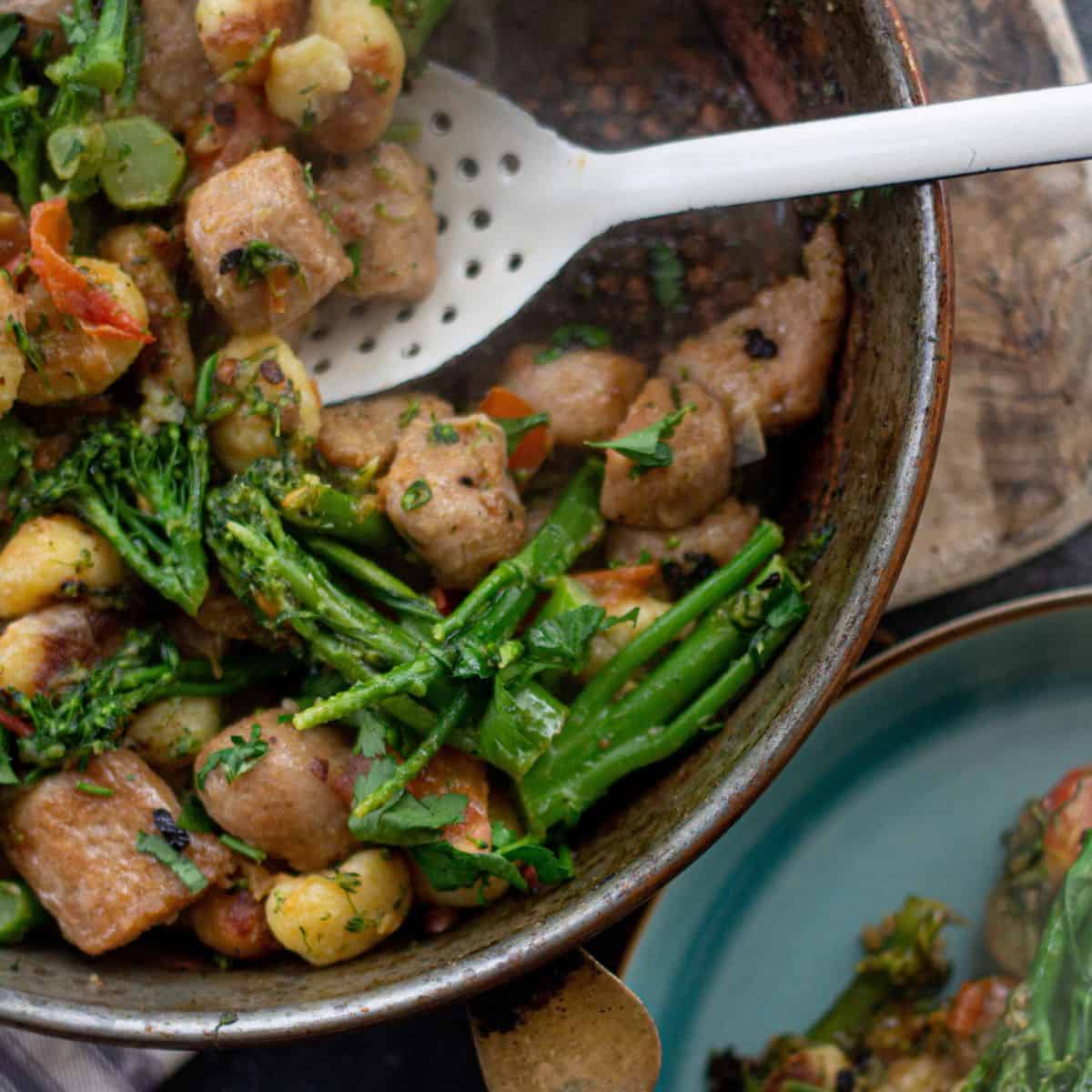 Gnocchi with sausage and broccoli in a pan