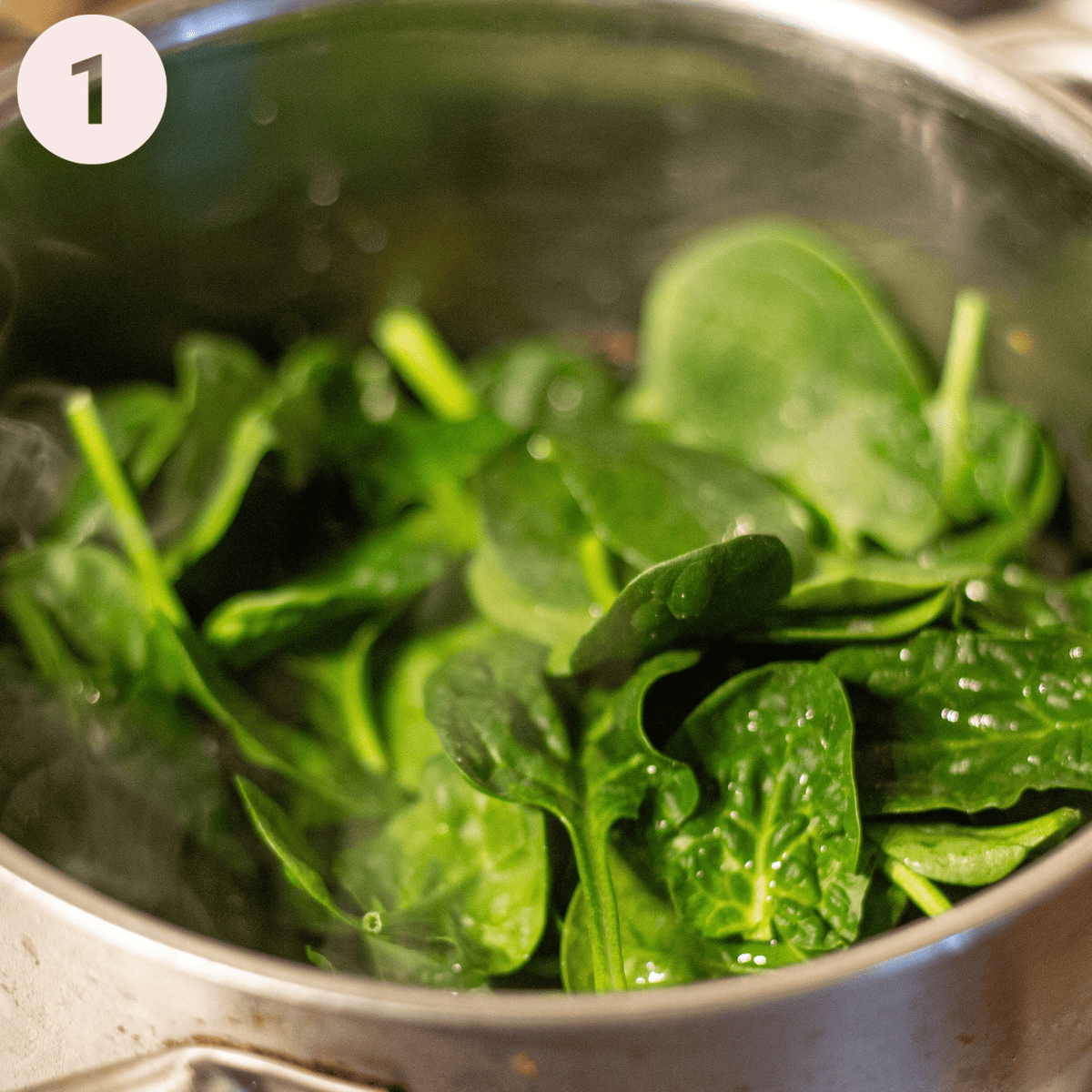 Cooking down spinach for a pasta stuffing.