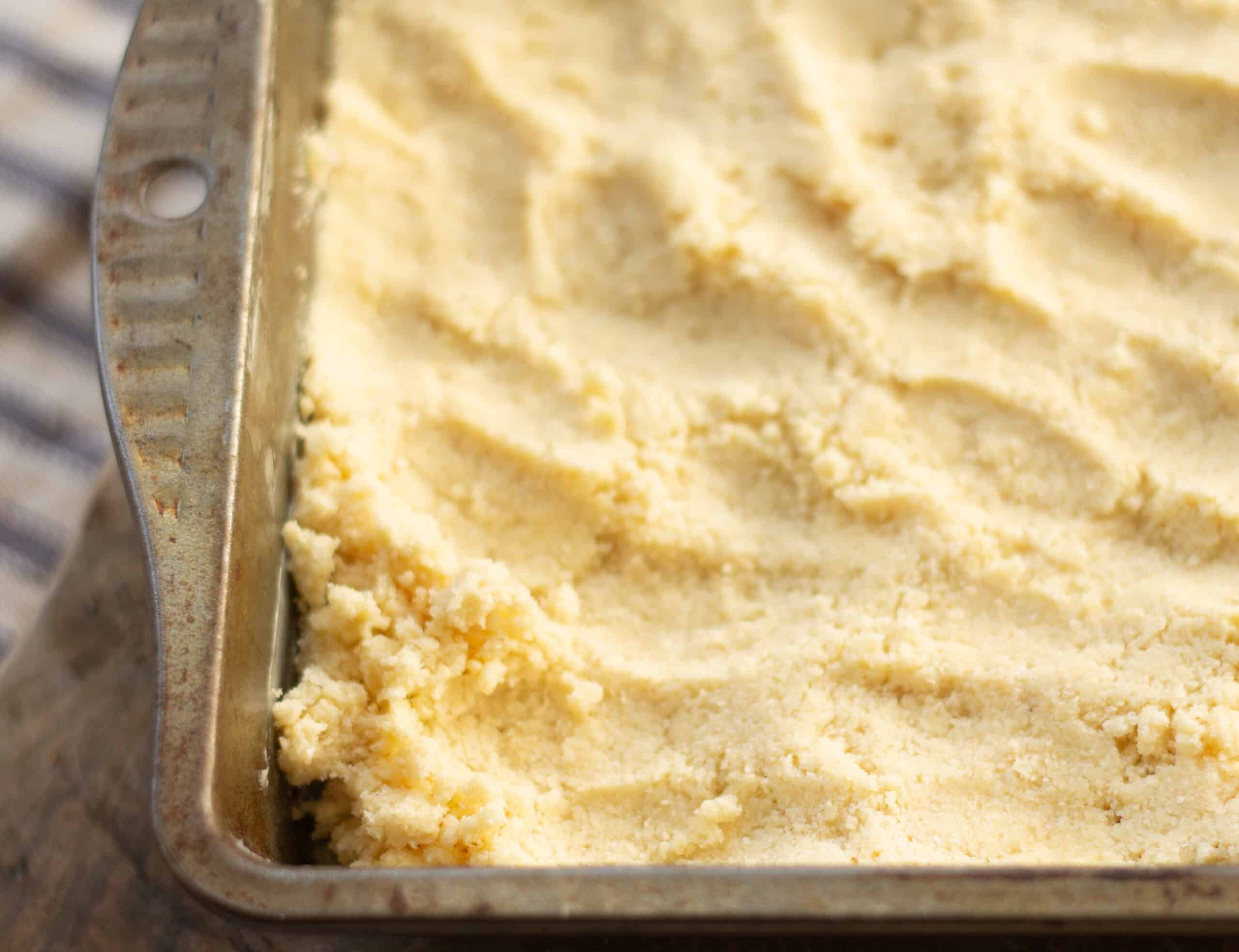 Pressing shortbread dough into a tin