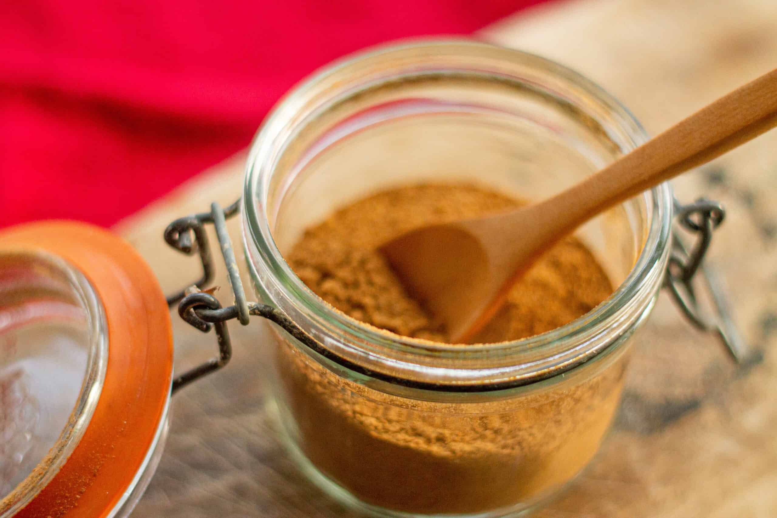 Placing chai powder into a jar