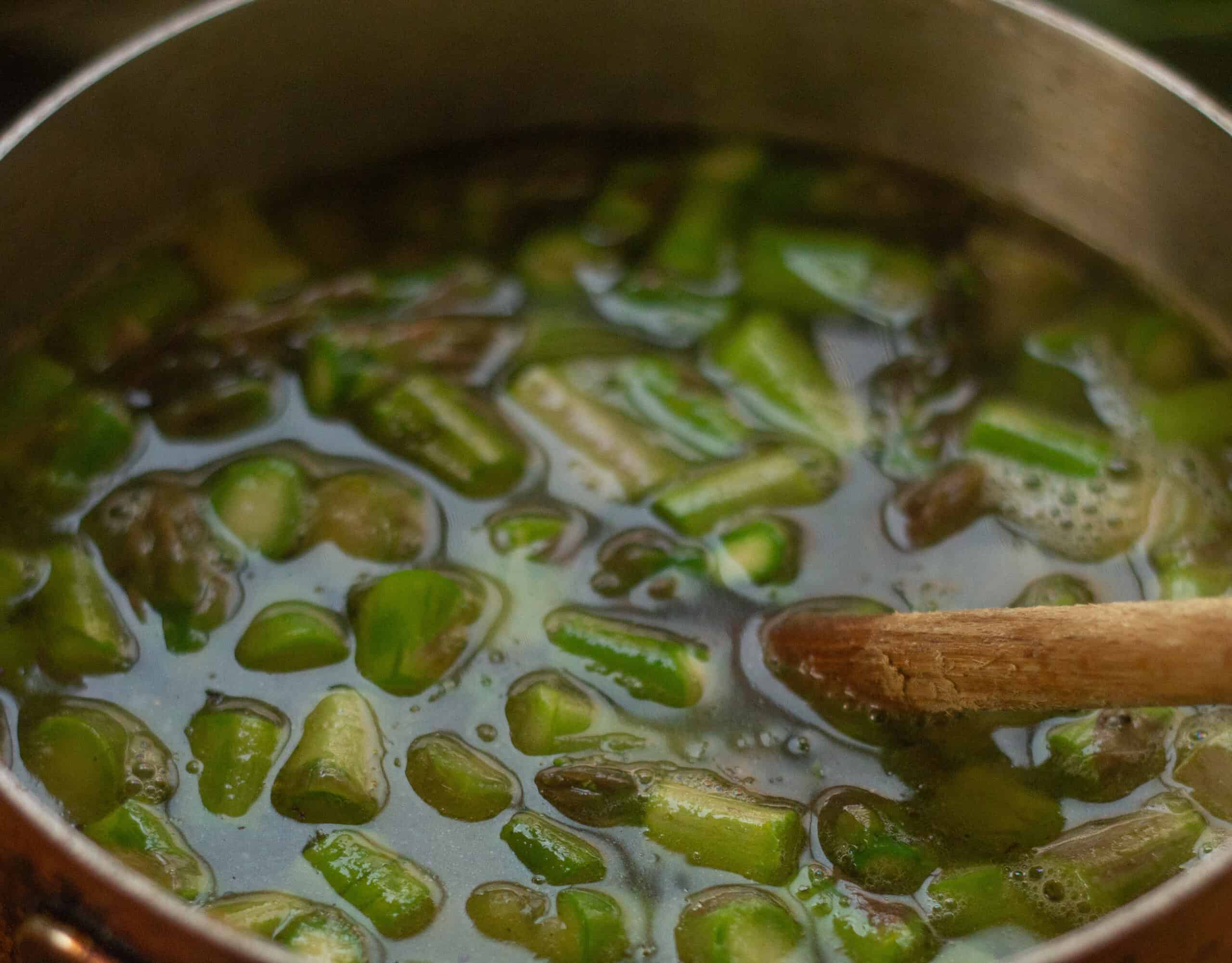 Adding stock to asparagus soup