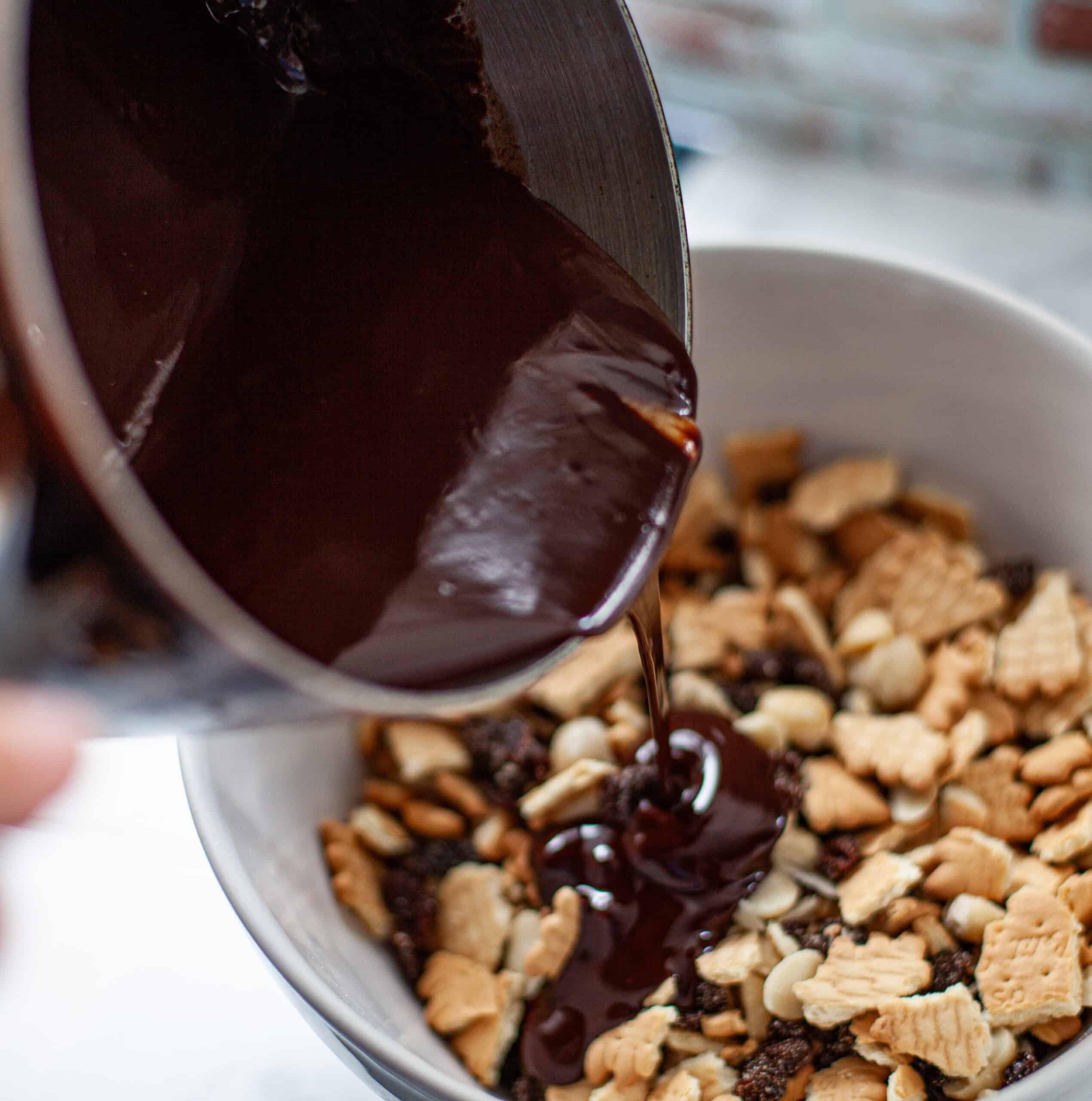 Mixing melted chocolate into biscuits