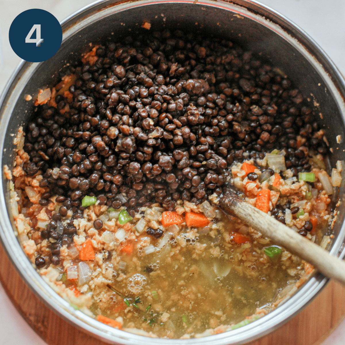 Adding cooked lentils to shepherds pie mix.