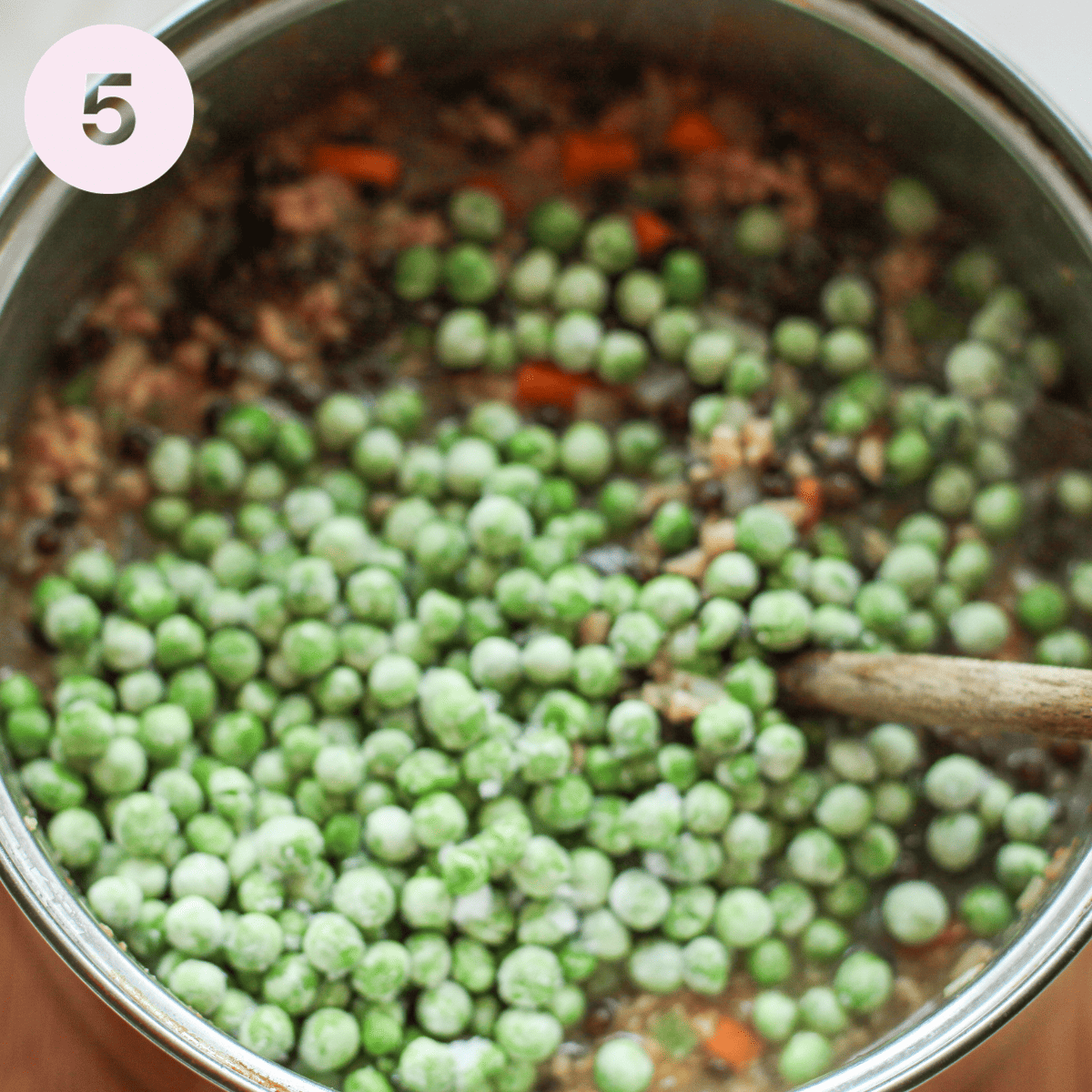 Adding frozen peas to shepherds pie.