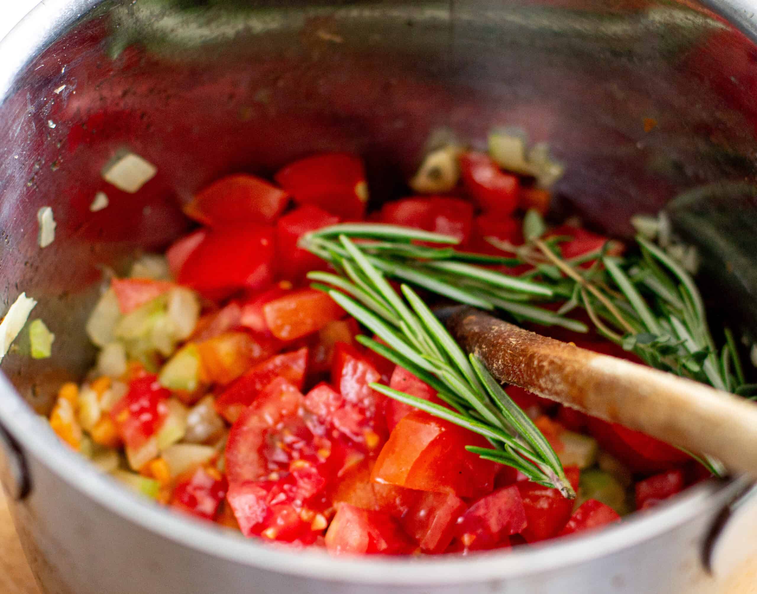 Adding tomatoes to soffritto