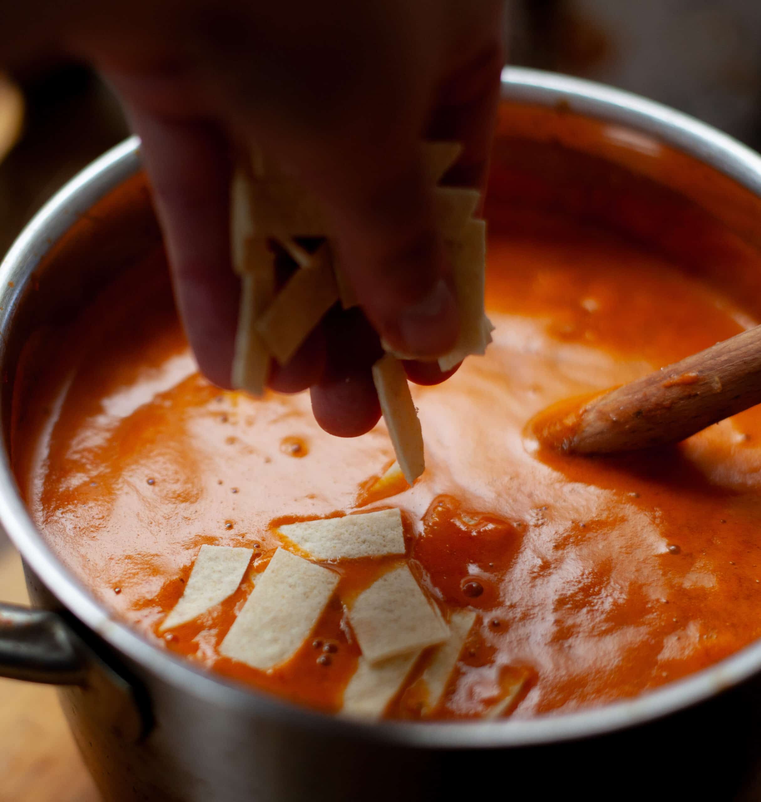 Adding tortillas to tortilla soup