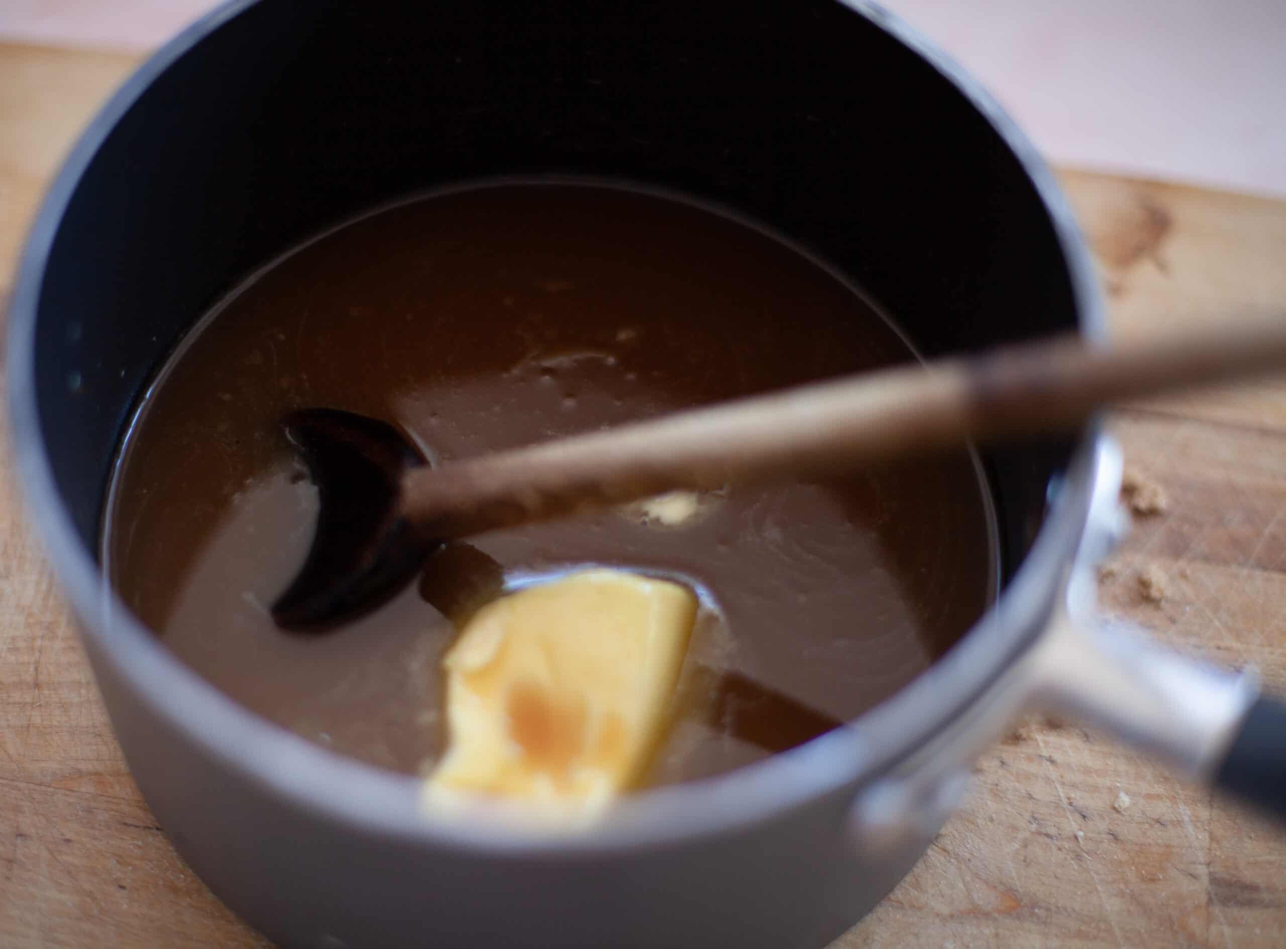 Adding butter to melted sugar