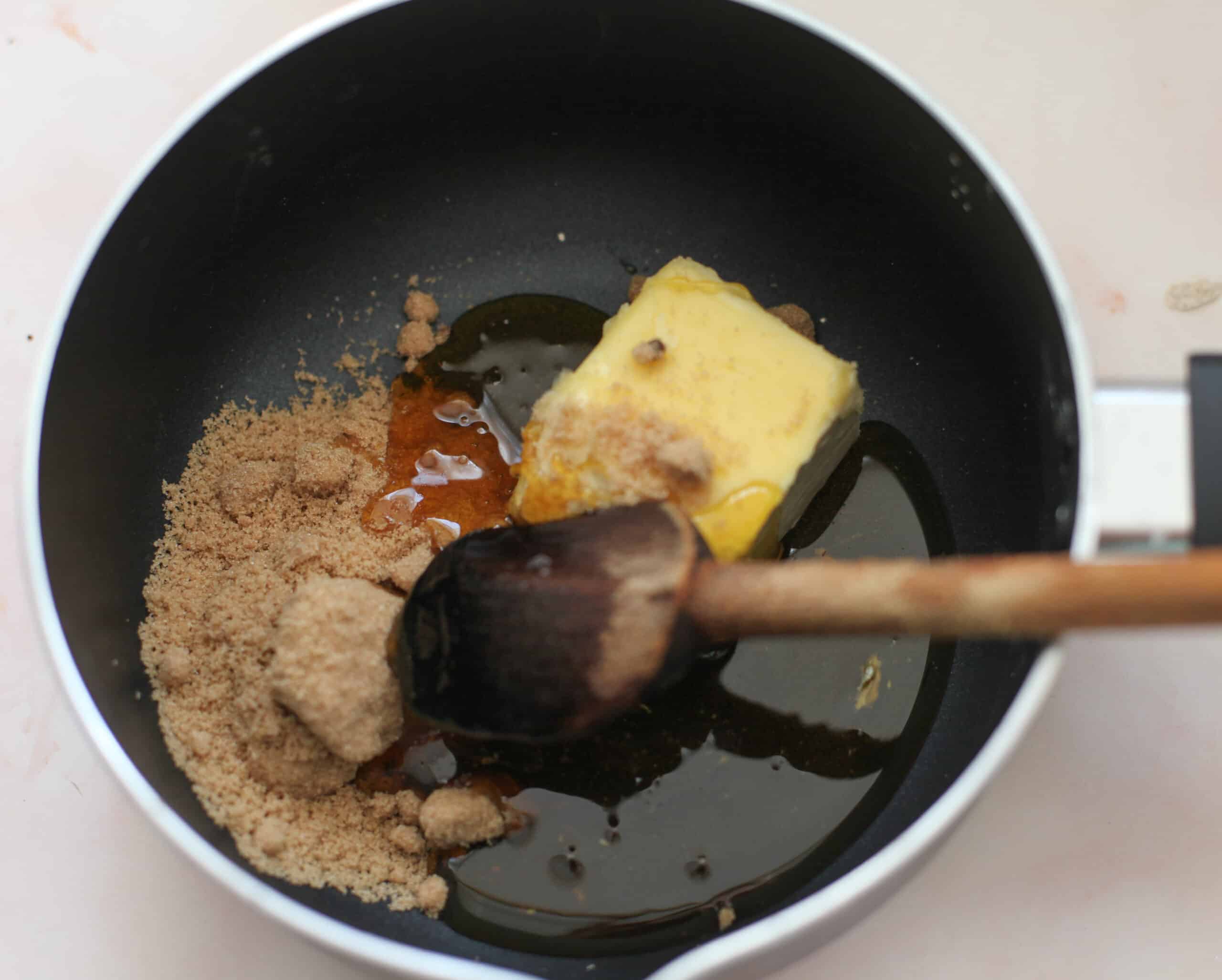Melting butter, sugar and golden syrup in a pan.