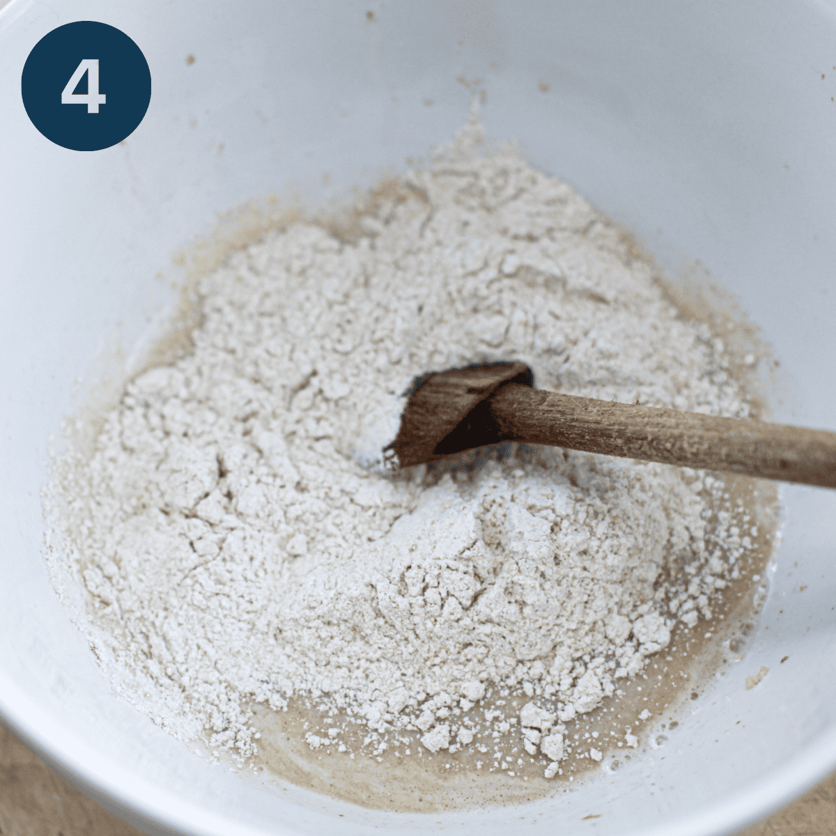 Adding flour to oatmeal mixture and mixing.