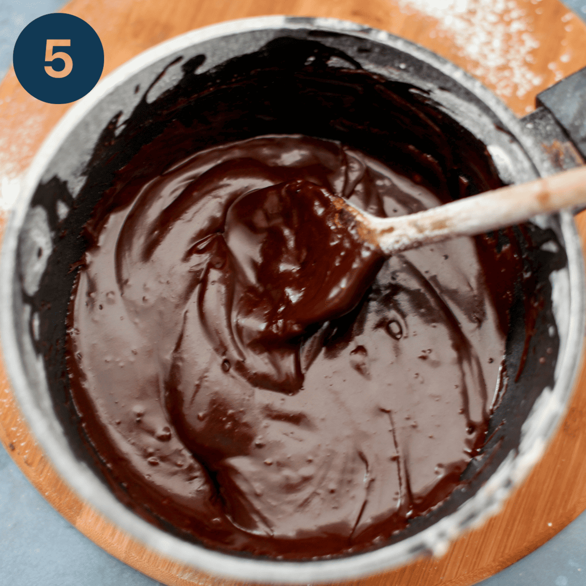 Beating boiling water into chocolate glaze.