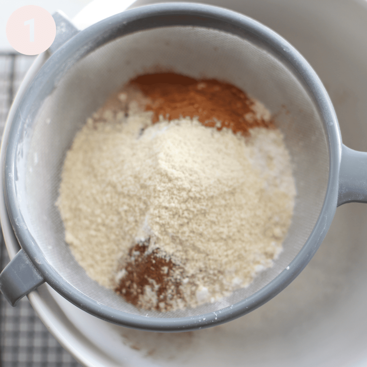 Sifting ingredients into a bowl.