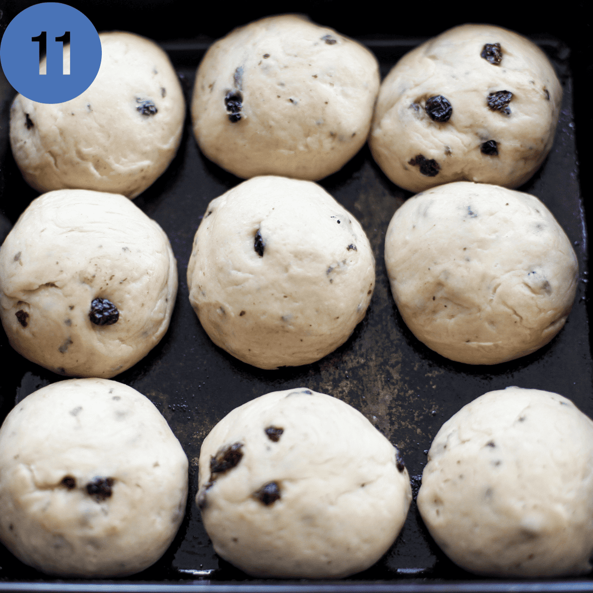 Rolled out dough balls, risen in a pan.