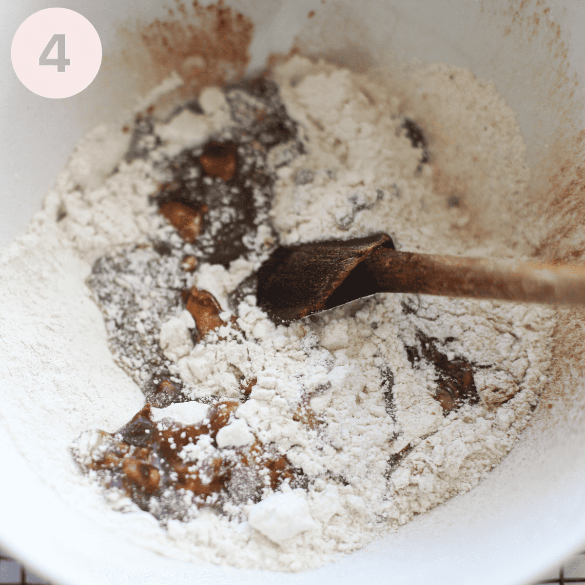 Stirring the sugar mixture into the flour.
