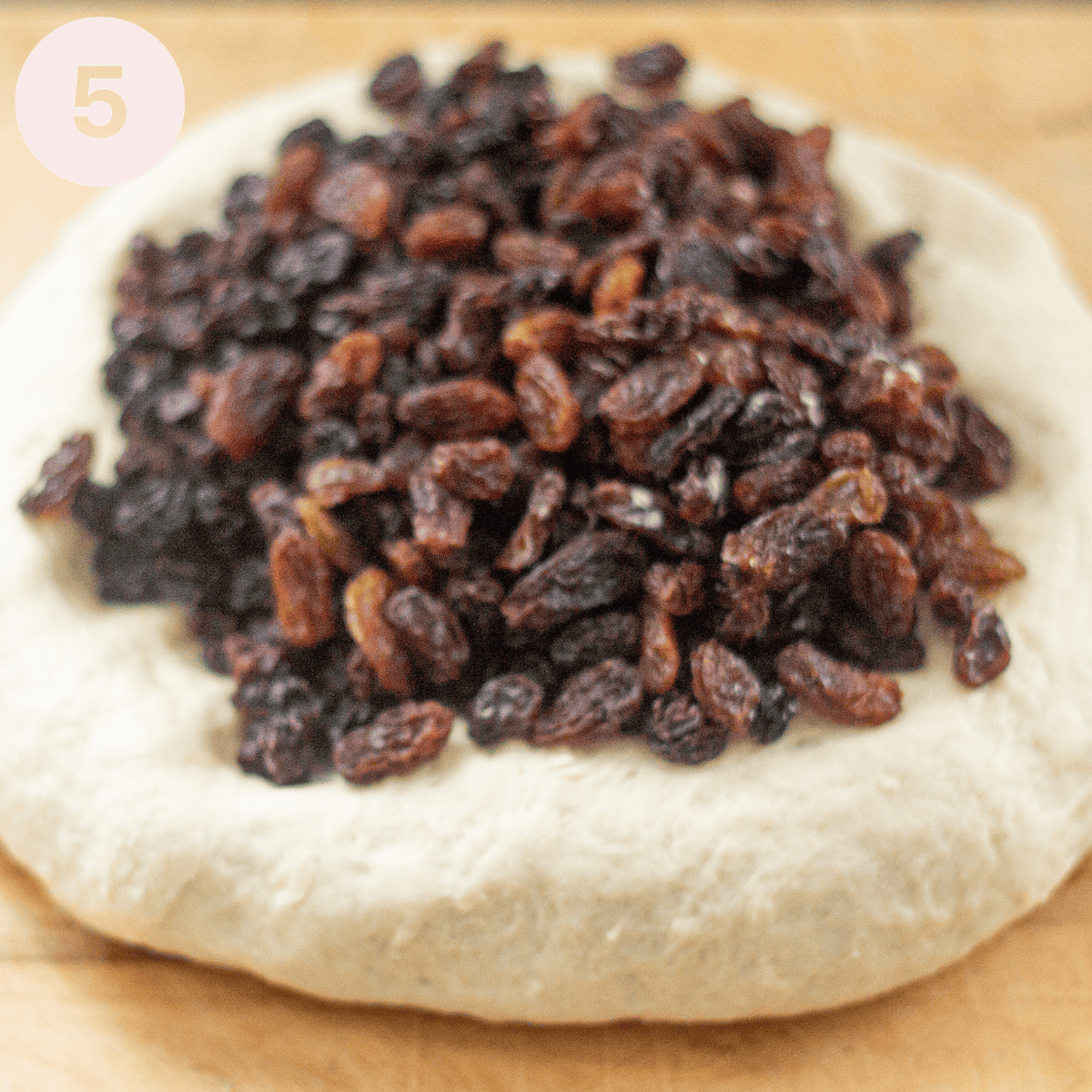 Adding dried fruit to dough.