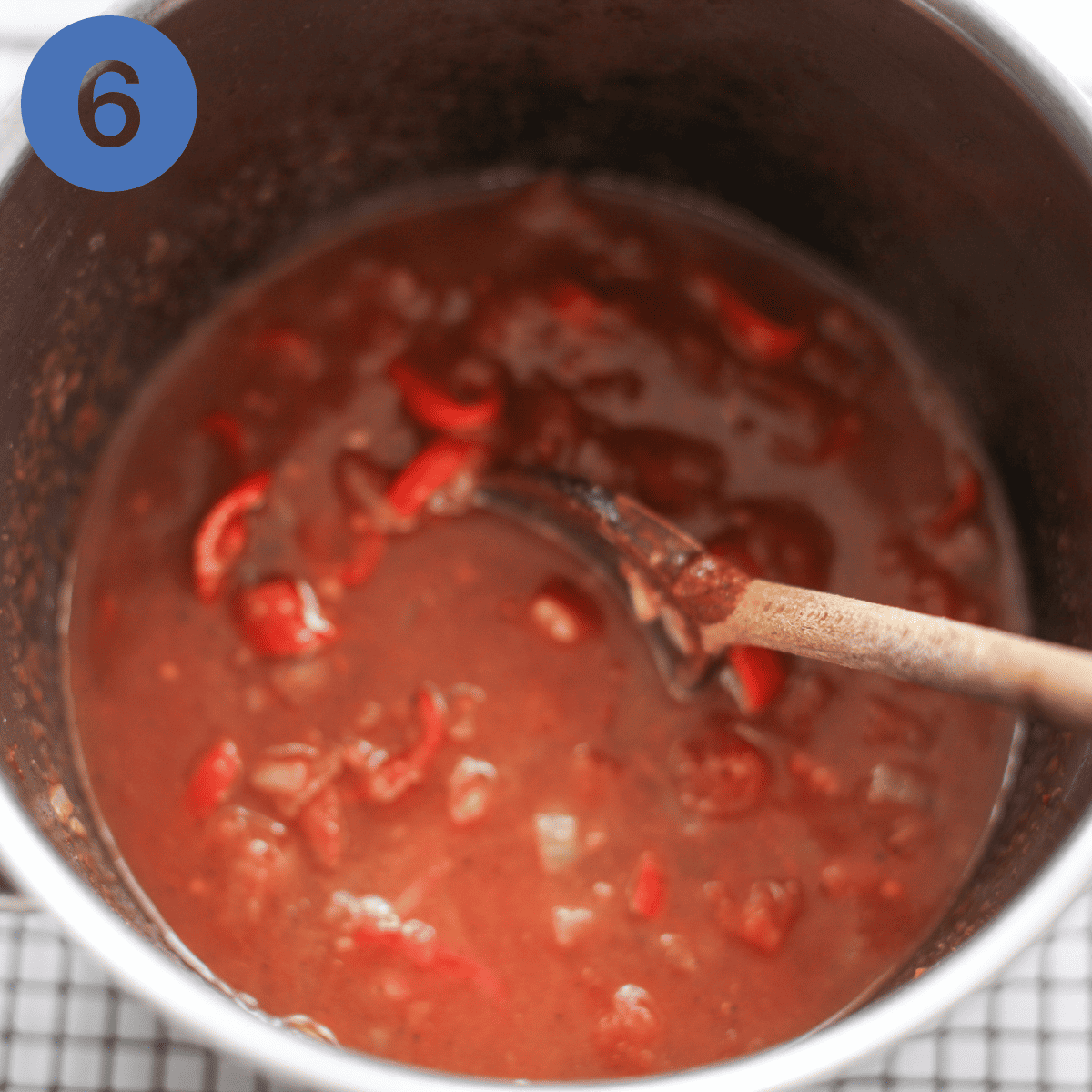 Adding tinned tomatoes to sauteed veg.