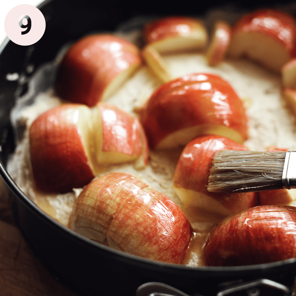 Brushing apples with melted butter.