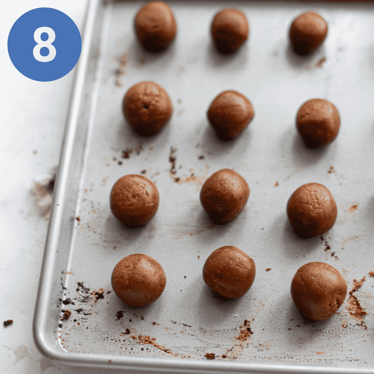 Cookie dough rolled out on a baking sheet.