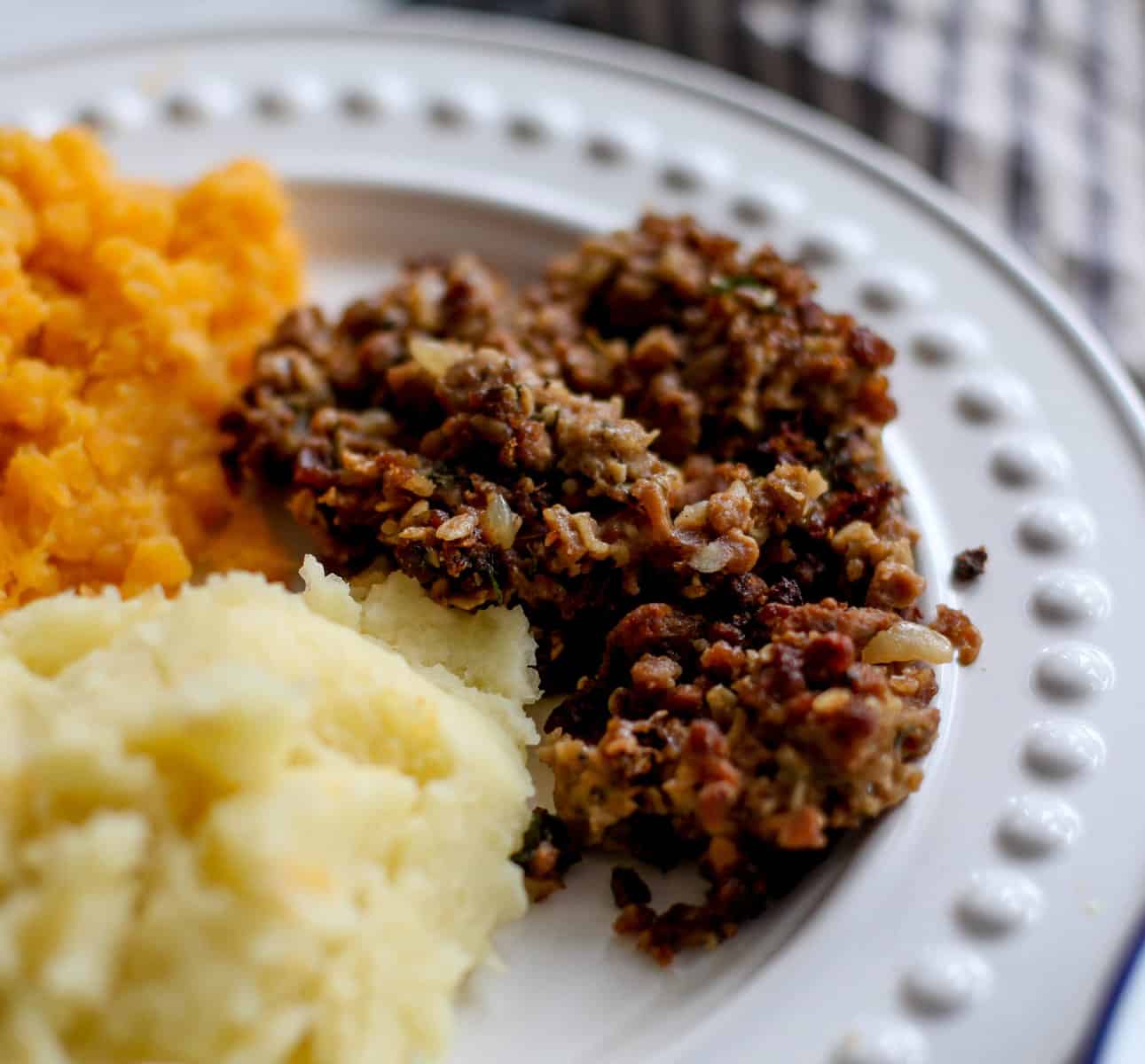 A closeup of haggis with neeps and tatties.