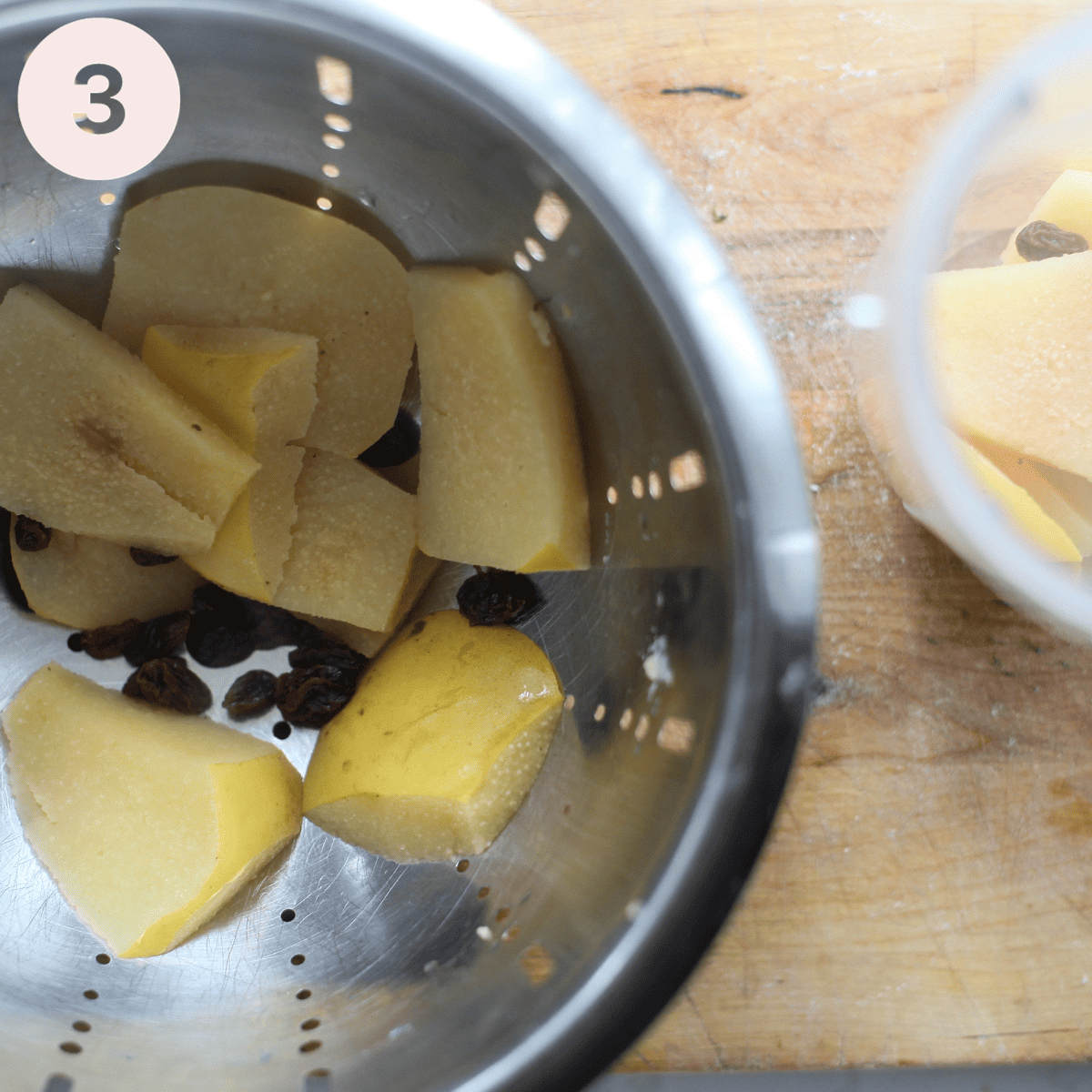 Draining the simmered quince.