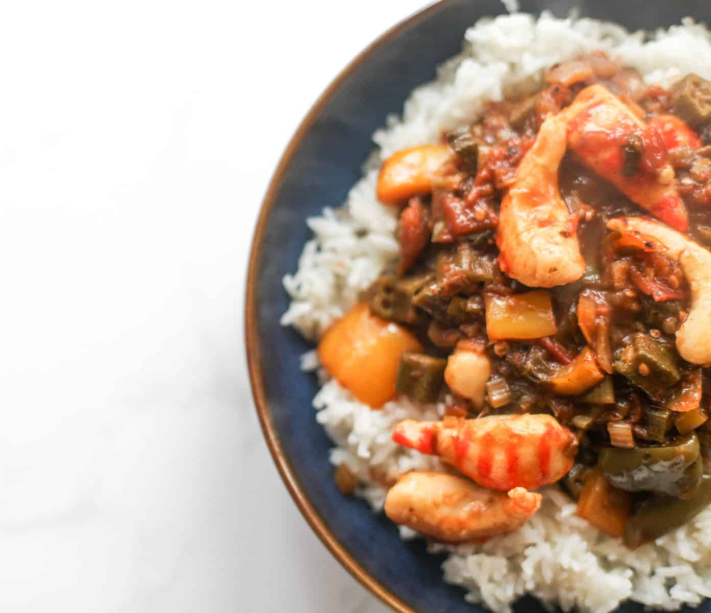 A bowl filled with boiled rice and creole.